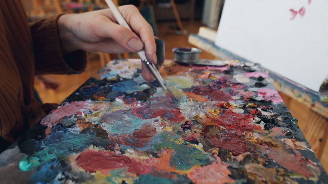 Students painting together in a bright art studio